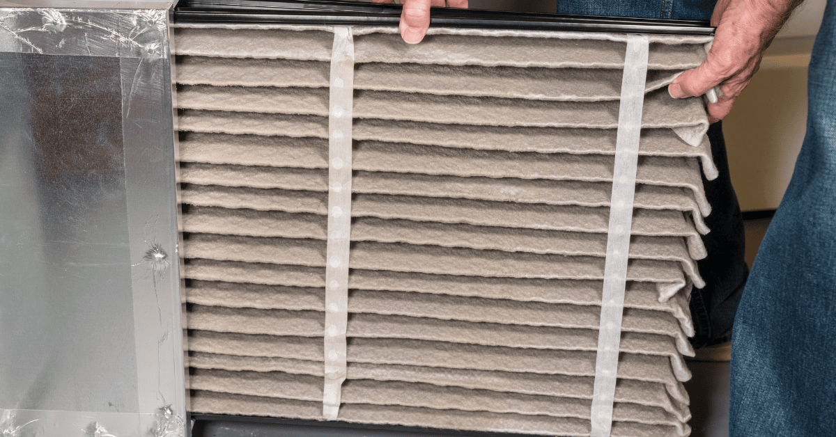 person removing dirty air filter