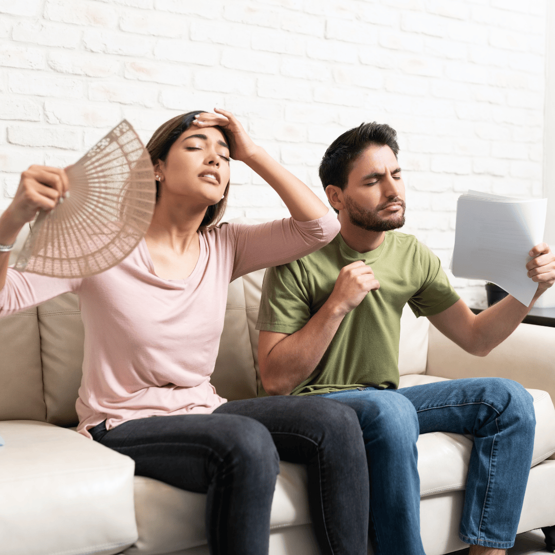 Man and woman fanning themselves off